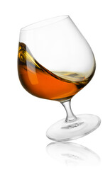 falling glass of cognac with splash isolated on white