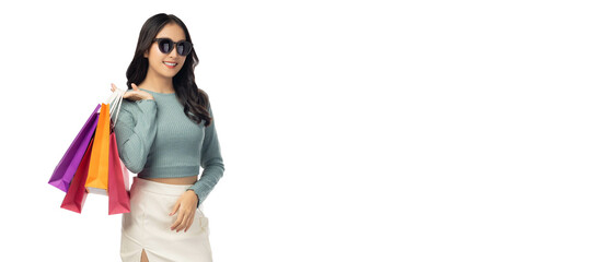 Excited beautiful woman wearing sunglasses hold shopping bags isolated on white background and copy...