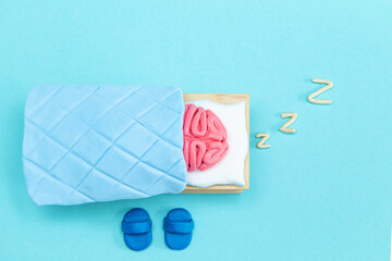Plasticine pink human brain is sleeping. Mind rest concept.