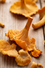 Fresh chanterelle mushrooms on a wooden table, focus on the mushroom inside, close-up