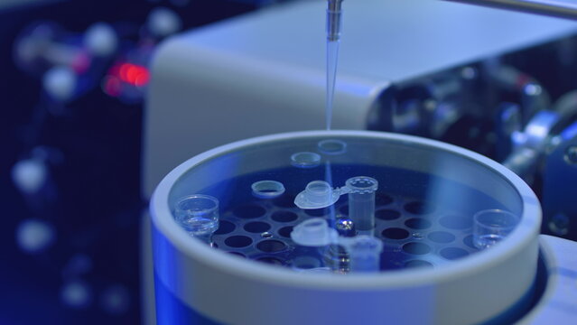 Apparatus for automatic sampling, analysis. A robo hand takes a sample from a test tube for testing or analysis. New technologies in science. Artificial intelligence is conducting an experiment