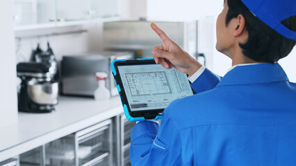 A worker checking the interior design on a tablet.