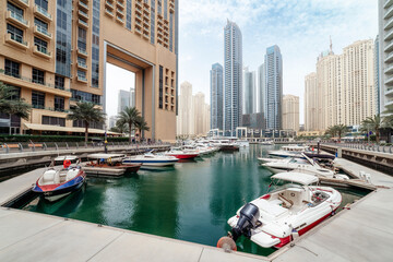 Dubai Marina district with skyscrapers, cruise boats, yachts and promenade, United Arab Emirates. High quality photo - 600127001
