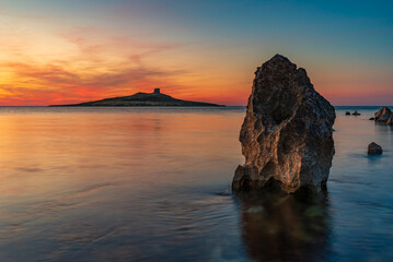 Sun setting behind the islet of Isola delle Femmine, province of Palermo IT - 600127283