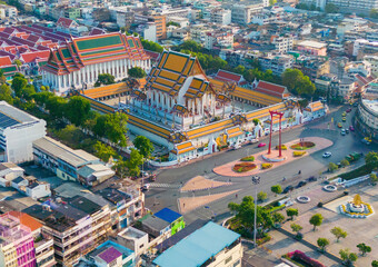 Aerial top view of Giant Swing or Sao Ching Cha monument with Wat Suthat temple at sunset in old...
