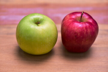 Fresh green and red apples laying on wooden table. Food concept, vegetables and fruits for weight loss, health promotion.