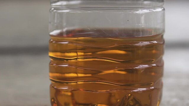 Refined biodiesel is placed in a clear plastic bottle.
