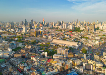 Fototapeta na wymiar Aerial view of Hua Lamphong or Bangkok Railway Terminal Station with skyscraper buildings in urban city, Bangkok downtown skyline, Thailand. Cars on traffic street road on highways.
