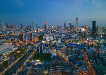 Fototapeta na wymiar Aerial view of Bangkok Downtown skyline, highway roads or street in Thailand. Financial district and business area in smart urban city. Skyscraper and high-rise buildings at night.