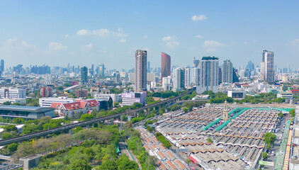 Naklejka na ściany i meble Aerial view of green trees in Lumpini Park, Sathorn district, Bangkok Downtown Skyline. Thailand. Financial district and business center in smart urban city in Asia. Skyscraper buildings