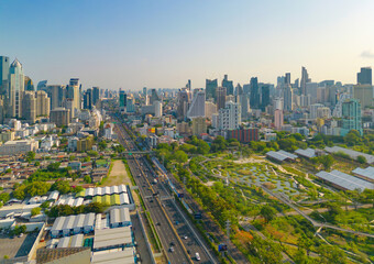 Fototapeta premium Aerial view of green trees in Lumpini Park, Sathorn district, Bangkok Downtown Skyline. Thailand. Financial district and business center in smart urban city in Asia. Skyscraper buildings