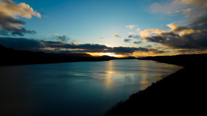 Fototapeta na wymiar sunset over the lake. The setting sun over the lake as the evening sun sets. wonderful sky