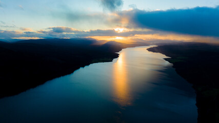 Fototapeta premium sunset over the lake. The setting sun over the lake as the evening sun sets. wonderful sky