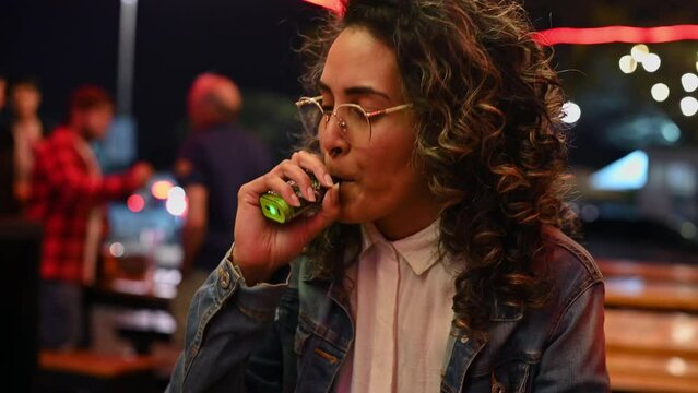 Woman seen vaping while sitting at a establishment