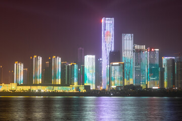 night view of high-rise buildings along Liuyang River near the junction with Xiangjiang river, Changsha, Hunan, China