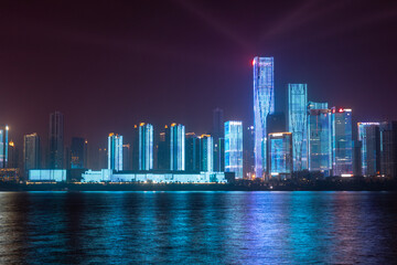 night view of high-rise buildings along Liuyang River near the junction with Xiangjiang river, Changsha, Hunan, China