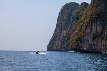 island phi phi leh and boat in thailand andaman sea. travel during vacation to the hot countries of...