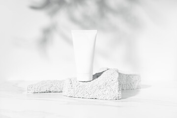 White mockup plastic bottle on pumice stones on white background.