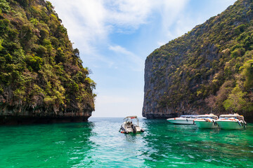 Pier or jetty on phi phi leh island in krabi in thailand near maya bay with boats and tourists on a hot sunny day. Travel and vacation.