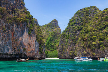 Pier or jetty on phi phi leh island in krabi in thailand near maya bay with boats and tourists on a...
