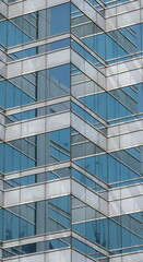 Fototapeta na wymiar Reflections in a modern office glass building