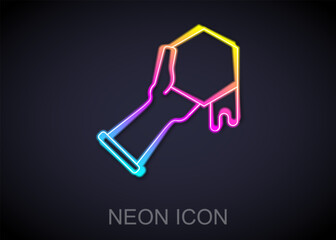 Glowing neon line Honeycomb and hand icon isolated on black background. Honey cells symbol. Sweet natural food. Vector