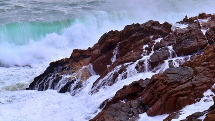 closeup of ocean waves crashing on rocks 