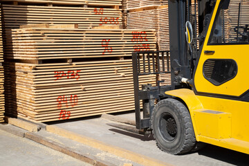 Sawing logs into boards.Timber products warehouse on a specialized site.
