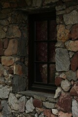 A wooden window on a stone building