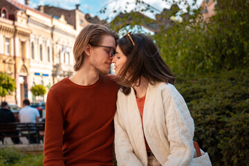 Fototapeta premium Portrait of young Caucasian couple relax in park. Romantic date in Valentine's Day