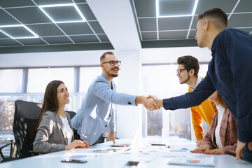 Close Up of business people shaking hands after contract meeting. Business etiquette,...