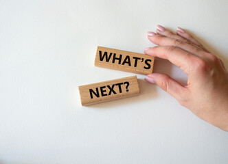 What is next symbol. Concept words What is next on wooden blocks. Beautiful white background. Businessman hand. Business and What is next concept. Copy space.