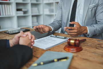 Lawyer or judge explaining details in documents and taking notes in a pocketbook according to legal and fair agreements Ethics and Integrity Hammer Litigation.