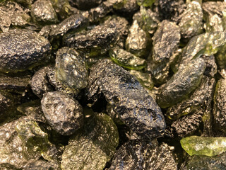 Piles of rough Moldavite stones 