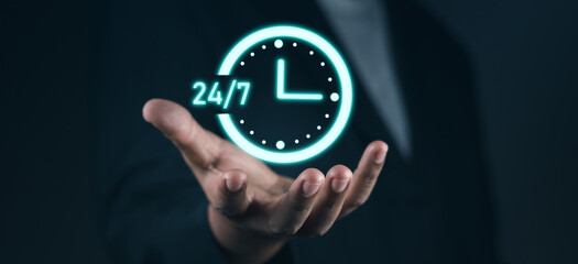 Customer service, nonstop service concept. Businessman hand holding virtual 24-7 with clock on hand for worldwide nonstop and full-time available contact of service concept.