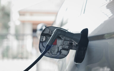 EV charging station for electric car in concept of green energy and eco power produced from sustainable source to supply to charger station in order to reduce CO2 emission .
