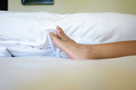 Body parts photos. Child's feet on a white mattress. Illustration for a staycation theme