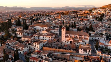 Fototapeta na wymiar Aerial view of Granada city, Albaicin district at sunset, old Moorish quarter of the city, located on a hill facing the Alhambra. Andalusia, Spain