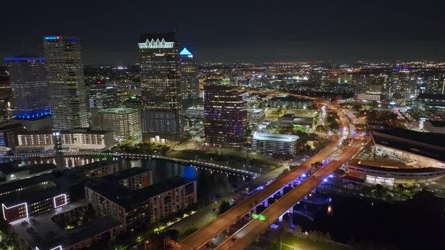 Aerial view of downtown district of Tampa city in Florida, USA. Brightly illuminated high skyscraper buildings and moving traffic in modern american midtown