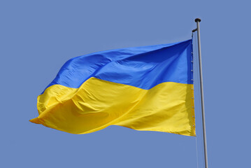 Ukrainian flag in the blue sky
