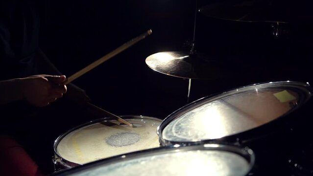 Unrecognizable musician man drummer is playing hitting drums and cymbals.