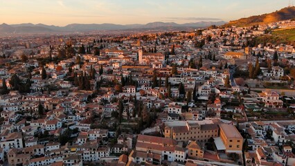 Obraz premium Aerial view of Granada city, Albaicin district at sunset, old Moorish quarter of the city, located on a hill facing the Alhambra. Andalusia, Spain