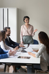 Business lady or coach lead group meeting or training in conference room. Clients take part in...
