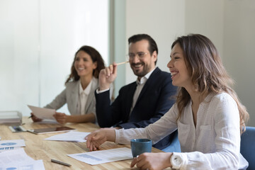 Young and ambitious entrepreneurs listen presentation during formal meeting in conference room,...