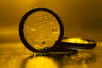 lens filters with water droplets reflected in the mirror