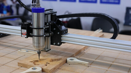 A drill bit on a wood carving machine. Professional milling machine for industrial wood carving.