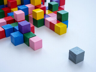 Fototapeta na wymiar The structure of multi-colored cubes and next to one gray. Creativity and individuality.