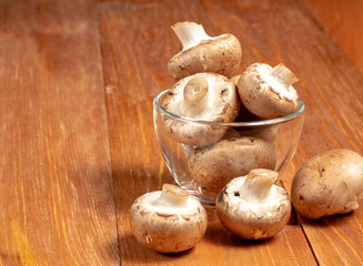 Mushrooms in a glass mug on a wooden table