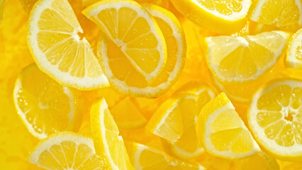 Top shot of lemon slices flying up in the air.
