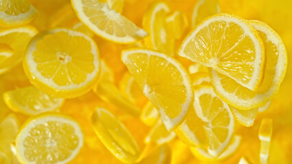 Top shot of lemon slices flying up in the air.